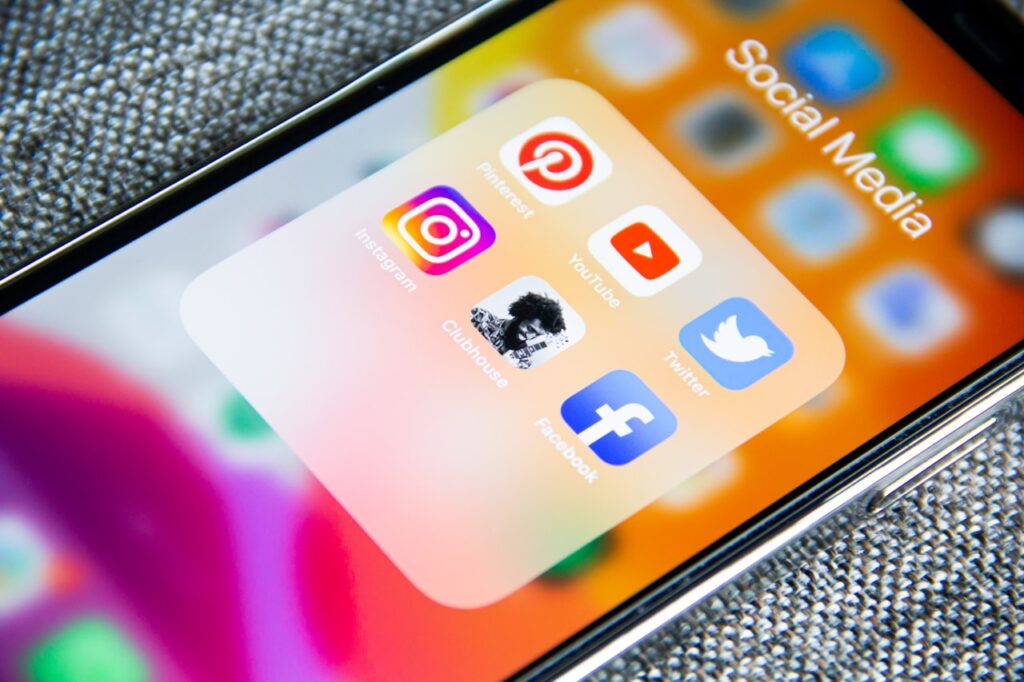 Social media marketing concept with smartphone displaying various social networking apps and time management icons